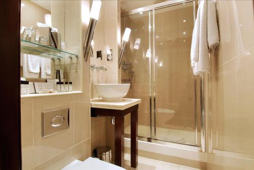 a bathroom with a shower and a sink at The Premier Notting Hill in London