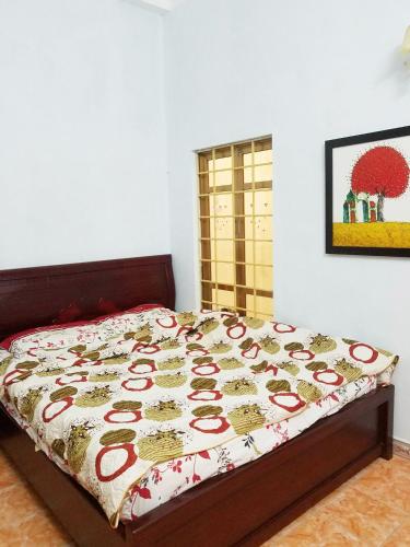 a bed with a quilt on it in a bedroom at Private room, international area, near Airport in Hai Phong