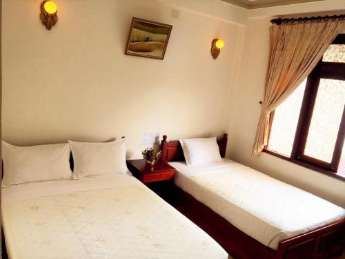 Ліжко або ліжка в номері Delight Hotel Mui Ne