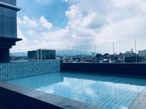 a swimming pool on the roof of a building at YELLO Hotel Paskal Bandung in Bandung