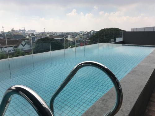 a swimming pool on the roof of a building at YELLO Hotel Paskal Bandung in Bandung
