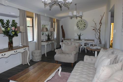 a living room with white furniture and a dining room at Pirralilla Estate Adelaide Hills in Aldgate