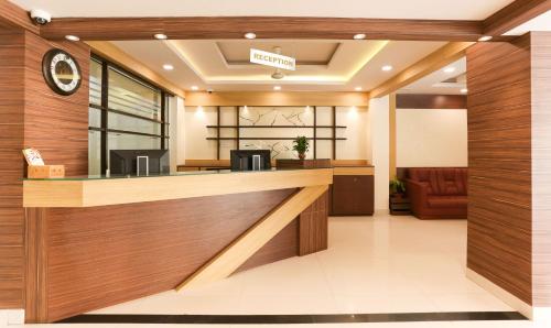 a lobby of a hospital with a reception counter at Itsy Hotels Worldtree Bellandur in Bengaluru