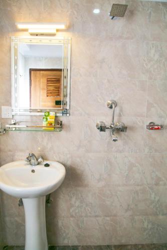 a bathroom with a sink and a mirror at Sakura Boutique Hotel in Kathmandu