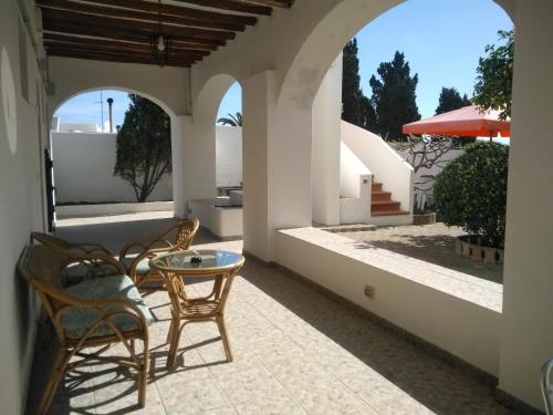 a patio with chairs and a table on a house at Villa Petrusa in Stromboli