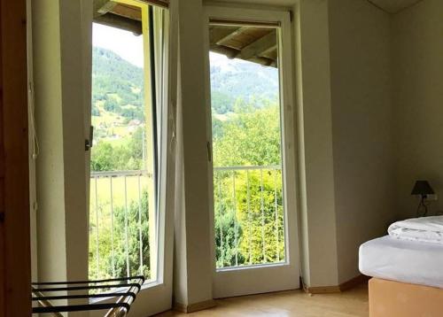 a bedroom with a large window with a view of a mountain at Ferienhaus Scharl in Schruns