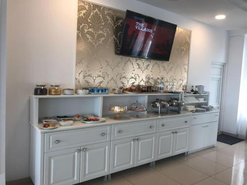 a large white display cabinet with dishes on it at Pensiunea La Vie in Blaj