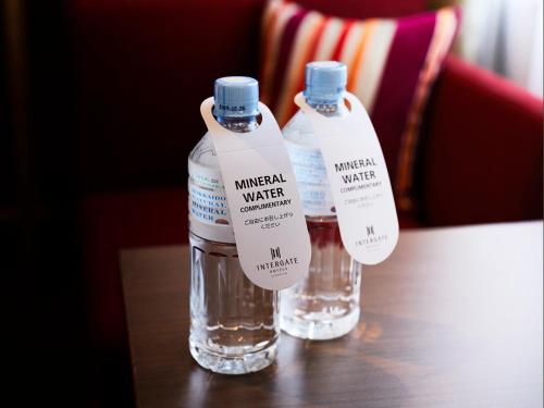 two bottles of water sitting on top of a table at Hotel Intergate Tokyo Kyobashi in Tokyo