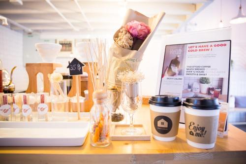 a counter with flowers and other items on it at Movylodge in Bangkok