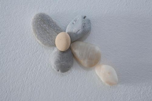 a group of rocks on a white wall at Dafnis Koufonisia in Koufonisia