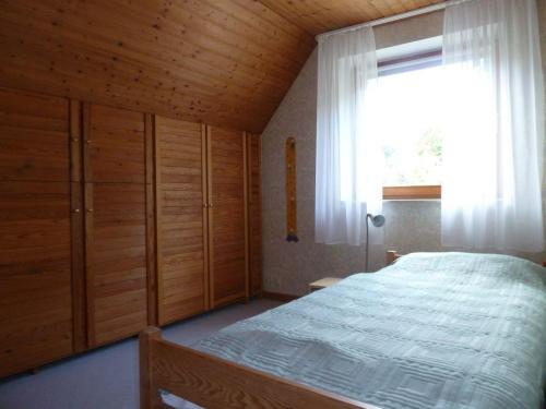a bedroom with a large bed and a window at Ferienwohnung Bedey in Kiel