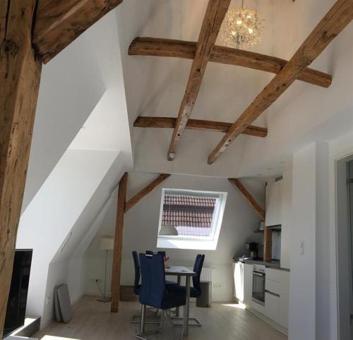 a kitchen with wooden beams and a table and chairs at Ferienwohnung Kiel - Kanalblick in Kiel