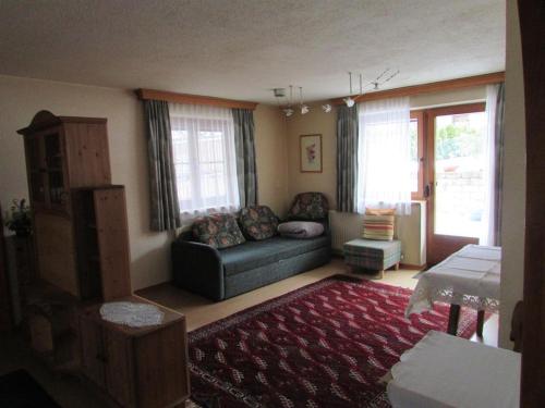 a living room with a couch and a rug at Ferienhäusl Hubert und Staller in Kaltenbach