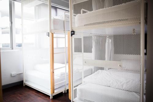 a room with a closet with white bunk beds at Movylodge in Bangkok