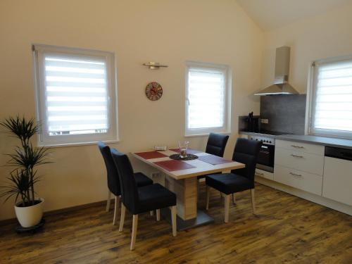a kitchen with a dining room table and chairs at Gasthof Reiterstuben in Hoßkirch