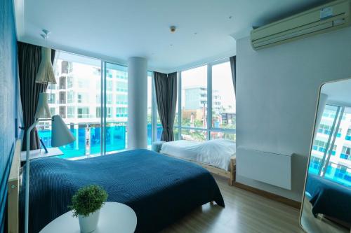 a bedroom with a bed and a large window at F304 My Resort Hua Hin in Hua Hin