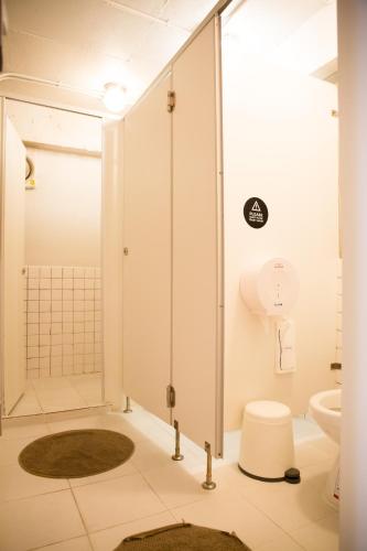 a bathroom with a shower and a toilet at Movylodge in Bangkok