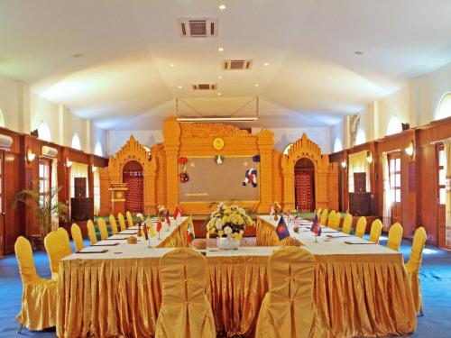 a large banquet hall with long tables and chairs at KMA Bagan Hotel River View in Bagan