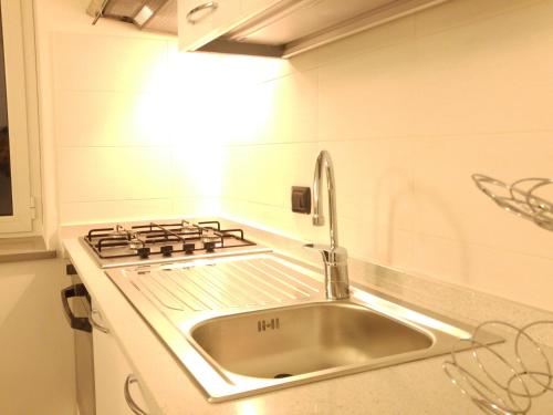 a kitchen with a sink and a stove at Il Cuore del Borgo - Holiday Home in Borgomaro