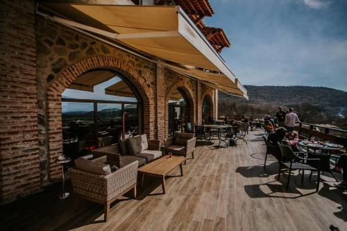 a patio with chairs and tables and people sitting at tables at Babaneuris Marani in Babaneuri