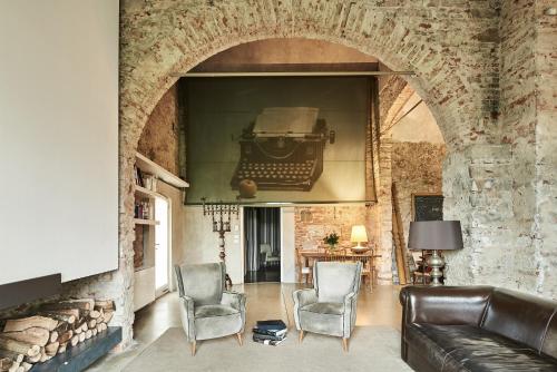 a living room with a couch and two chairs at Riva Lofts Florence in Florence