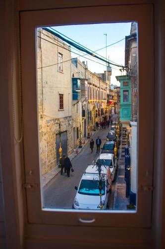 a view from a window of a street with cars at Casa Azzopardi Suites in Rabat