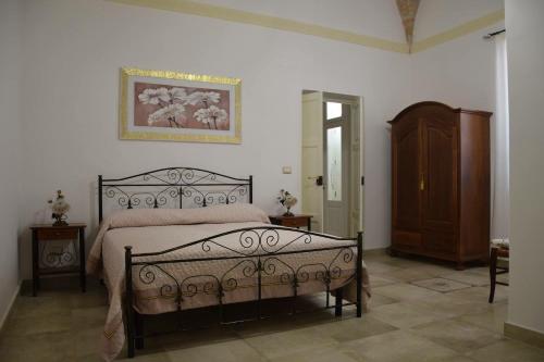a bedroom with a bed and a dresser in it at Le Tenute di Agnese in Felline