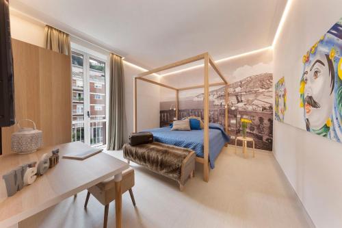 Ulisse Apartment في سورينتو: غرفة نوم مع سرير المظلة ومكتب