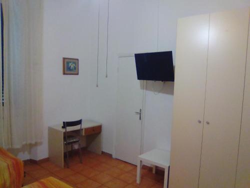 a room with a desk and a table and a chair at Albergo Cavour SELF CHECK-IN in Livorno