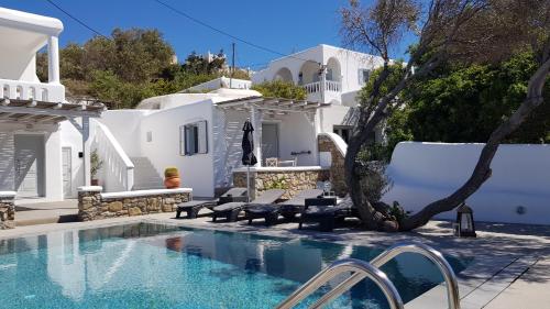 a villa with a swimming pool and white buildings at Villa Varnali Small Boutique in M&yacute;konos City