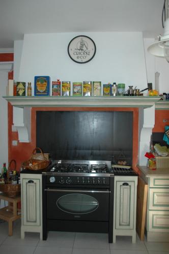 a kitchen with a stove top oven in a kitchen at La Gravelière in Rémuzat