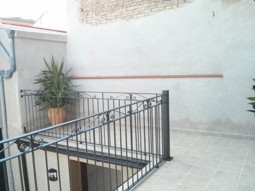 a stairway with a wrought iron gate and plants at Cal Blai in Móra la Nova