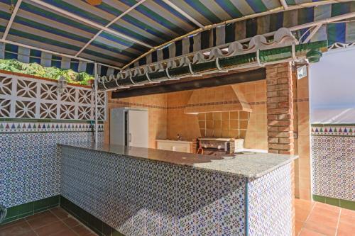 an outdoor kitchen with a counter top and a stove at Cubo's Villa Marieli Chilches in Chilches