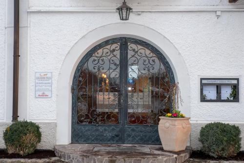 a door to a building with a flower pot in front at Landgasthof Goldener Pflug in Frasdorf