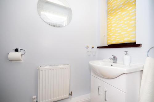 a white bathroom with a sink and a mirror at Northwood Park East in Stoke on Trent