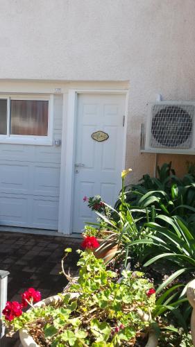 a white garage door with a plaque on it at Alona in Kefar Weradim