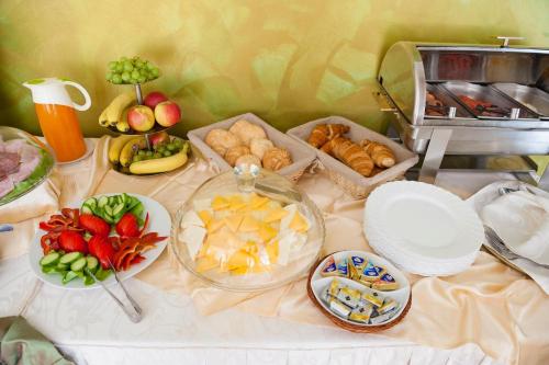 a table topped with plates and bowls of food at Hotel Corvaris in Bucharest