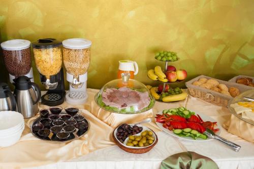 a table with a bunch of different types of food at Hotel Corvaris in Bucharest
