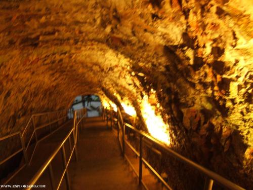 a tunnel in a cave with lights in it at Rifugio Delle Grotte in Castellana Grotte
