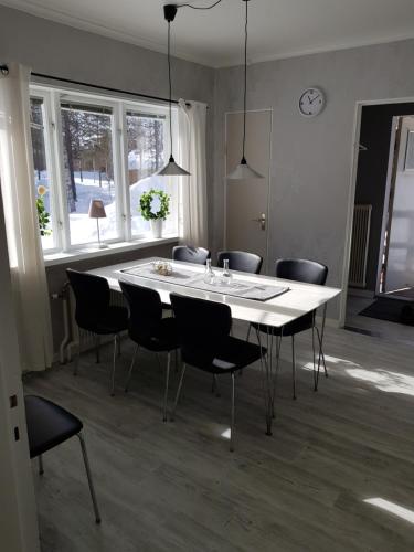 a dining room with a white table and chairs at Voxnabruks Kanot & Camping in Voxnabruk
