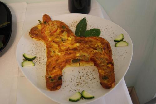 a white plate with a piece of food on it at Residence Aprilia in Grado