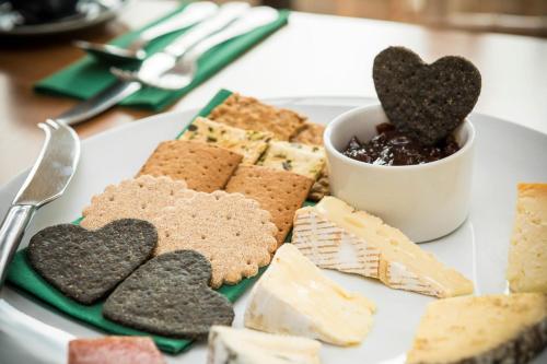 a plate of cookies and crackers on a table at Woodlands Lodge Hotel in Bartley