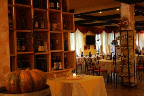 a room with a table with bottles of wine and a candle at Park Hotel in Chieri