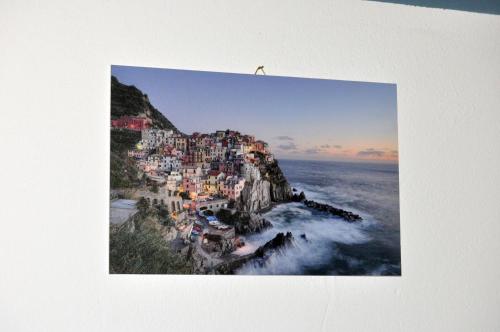 a picture of a town on a cliff next to the ocean at Nibea Suite Apartment in Manarola