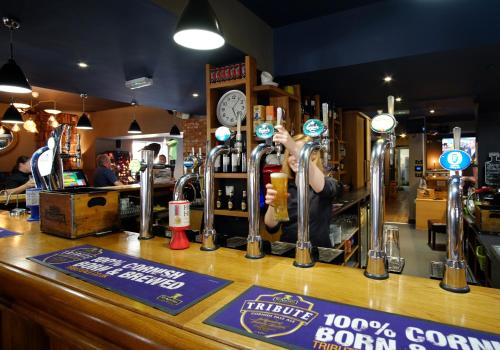 a bartender at a bar in a pub at Stones Hotel and Bar in Minehead