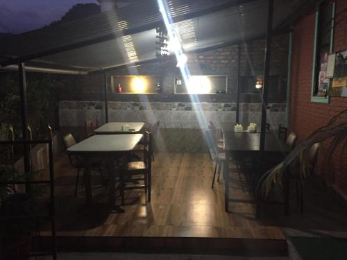 a dining room with tables and chairs at night at Harry Guest House & Restaurant in Pokhara
