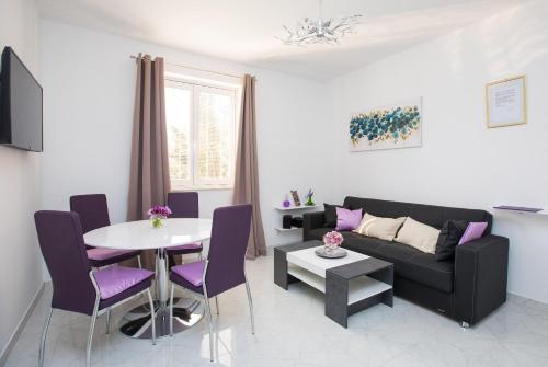 a living room with a couch and a table at Concordia Apartments in Dubrovnik