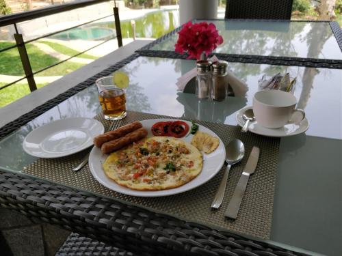 a table with a plate of food on a table at The Birchwood Retreat, Madikeri in Madikeri