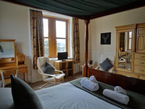 a bedroom with a bed with two white towels on it at Kilchoan Hotel in Kilchoan