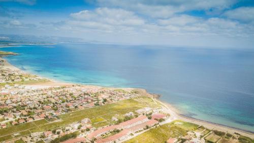 an aerial view of a beach and the ocean at La Villa delle Spezie in Marzamemi